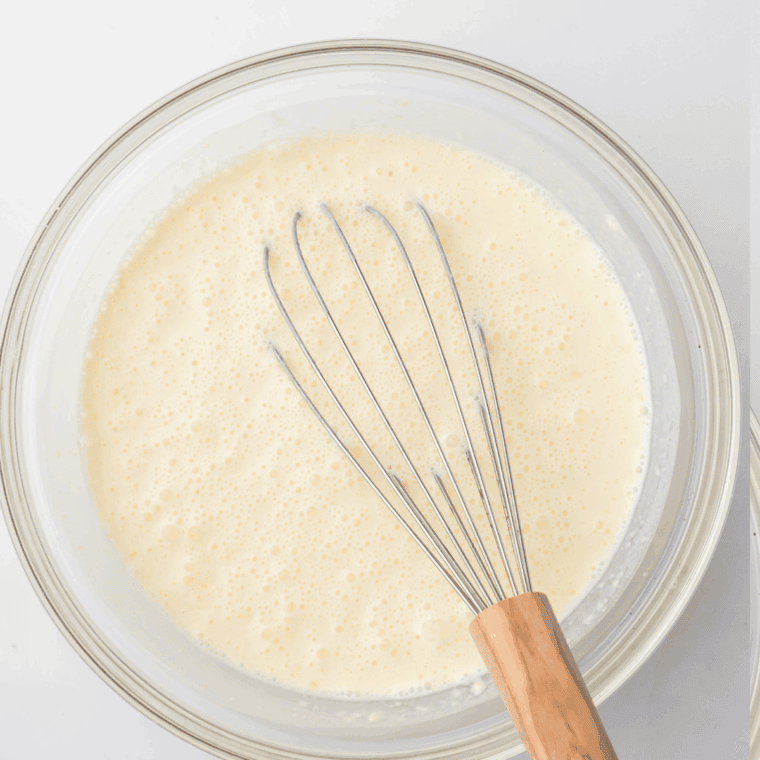 In a large mixing bowl, mix together the egg nog, milk and nutmeg, mix well.