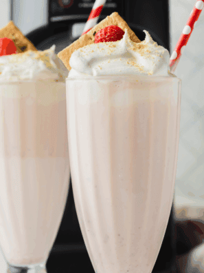 Creamy Ninja Slushi Eggnog Milkshake topped with whipped cream and nutmeg, served in a holiday glass.