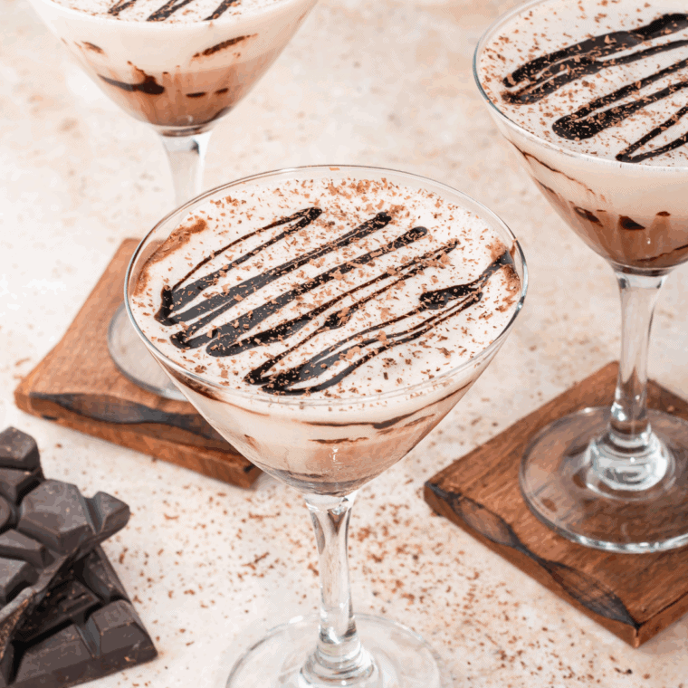 Glass of Ninja Slushi Frozen Chocolate Martini topped with whipped cream and chocolate drizzle, ready to serve.