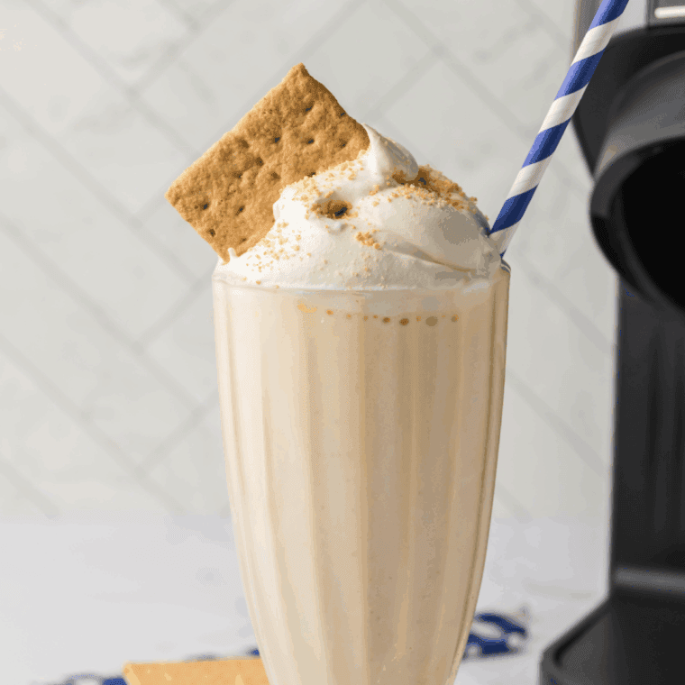 Ninja Slushi Protein Milkshake in a glass with a straw, creamy and ready to enjoy.