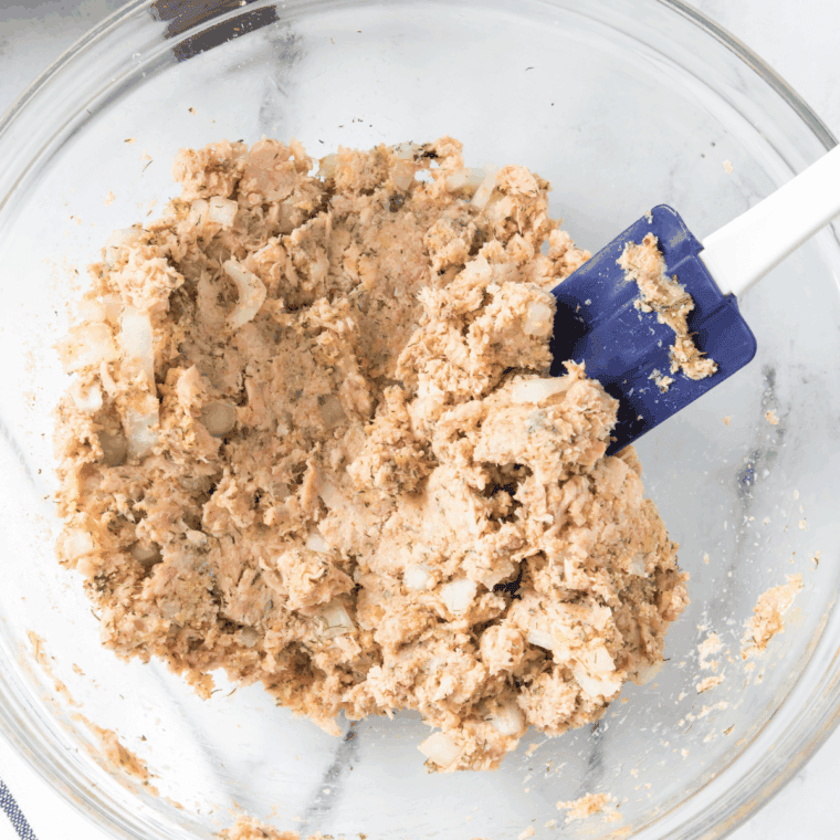 Stirring ingredients together until fully combined and evenly mixed in the bowl.