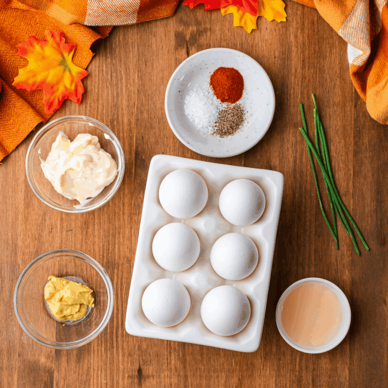 Ingredients needed for Pumpkin Deviled Eggs – A Festive Twist for Halloween or Thanksgiving! on kitchen table.