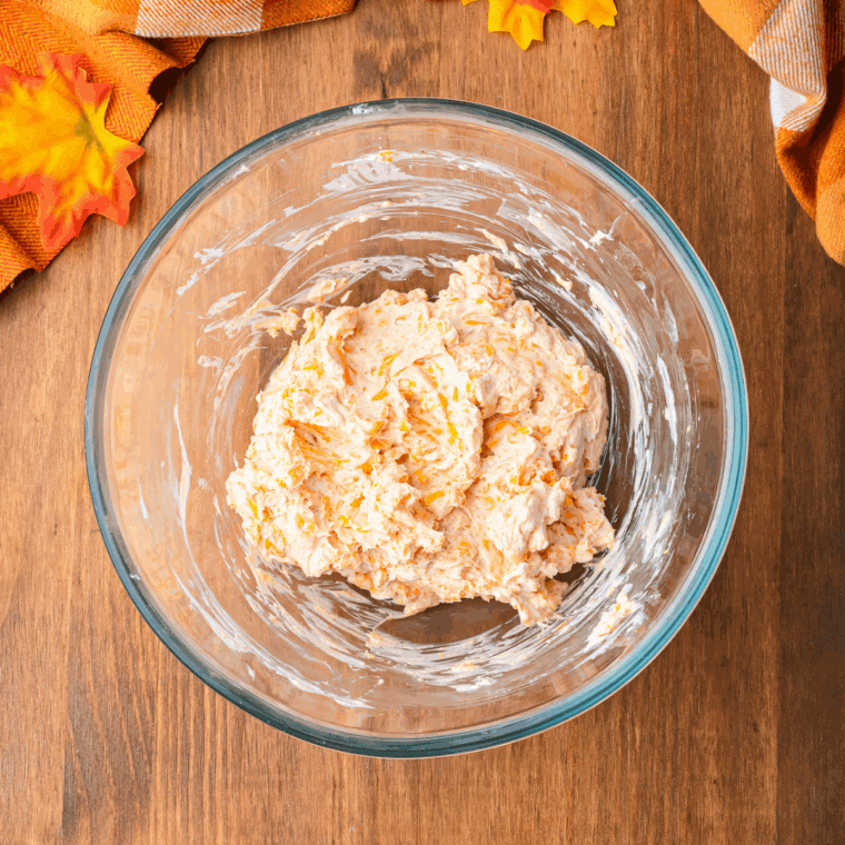 Mixing cream cheese, shredded cheddar, garlic powder, onion powder, and smoked paprika in a large bowl until smooth.