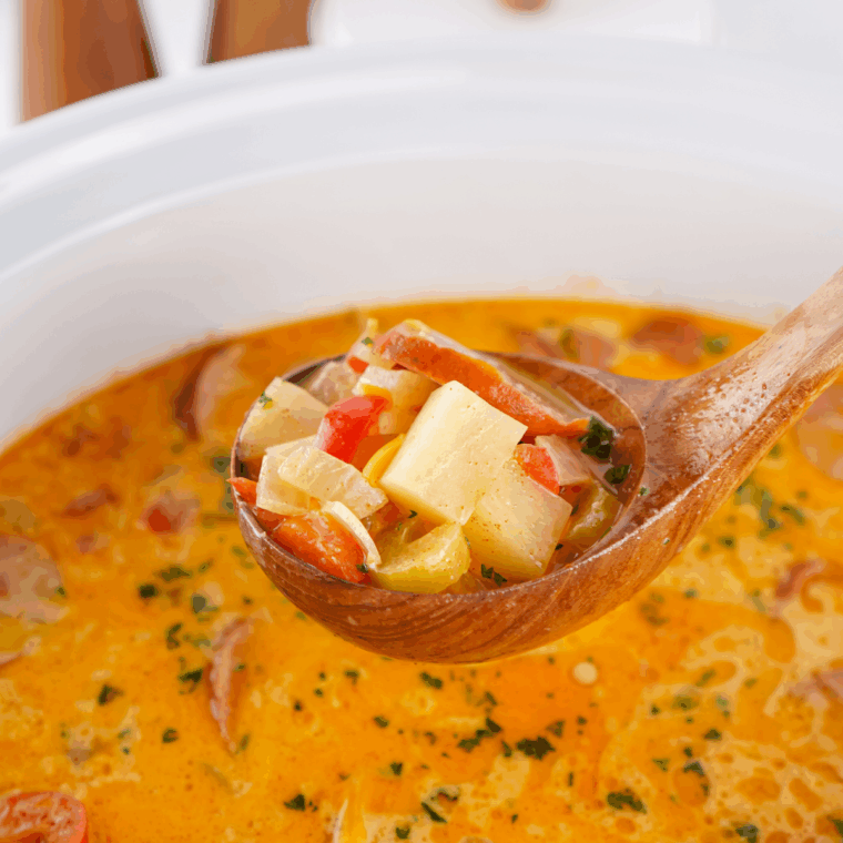 Bowl of creamy Red Lobster-style bacon potato soup topped with crispy bacon and green onions.