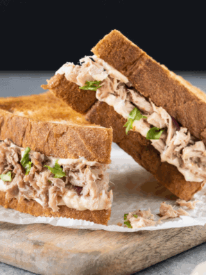 Subway-style tuna sandwich with creamy filling on fresh bread, ready to eat.
