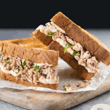 Subway-style tuna sandwich with creamy filling on fresh bread, ready to eat.