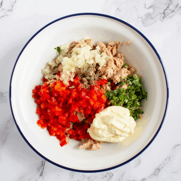 Tasting tuna salad and adjusting with extra lemon juice, pepper, or herbs.