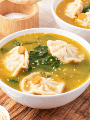 Bowl of Trader Joe’s Famous Wonton Soup with tender wontons and fresh greens in savory broth.