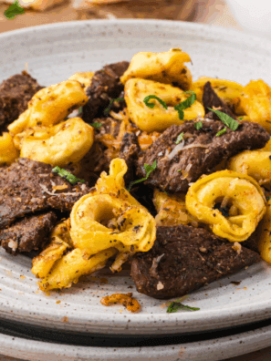 Copycat Maggiano’s Beef Tenderloin Medallions served with creamy balsamic mushroom sauce on a white plate.