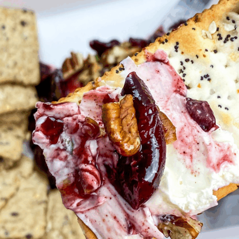 Creamy block of cream cheese topped with warm cherry sauce and served with crackers.