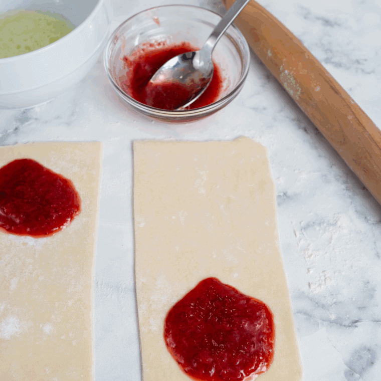 Prepare the Pie Crust: Pie crust rolled out and cut into rectangular shapes on a flat surface.