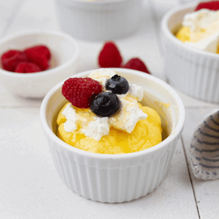 Fluffy golden air fryer soufflé served in ramekin, dusted with powdered sugar