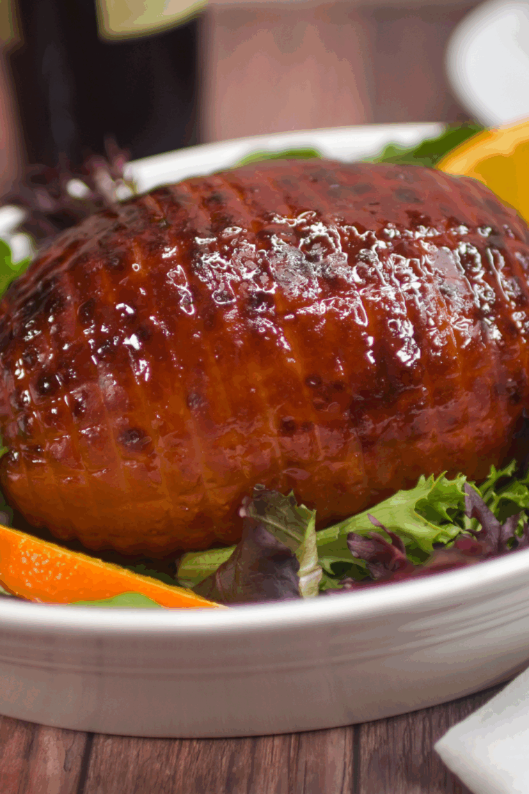 Sliced, fully cooked Amish ham with a sweet, sticky glaze ready for carving.