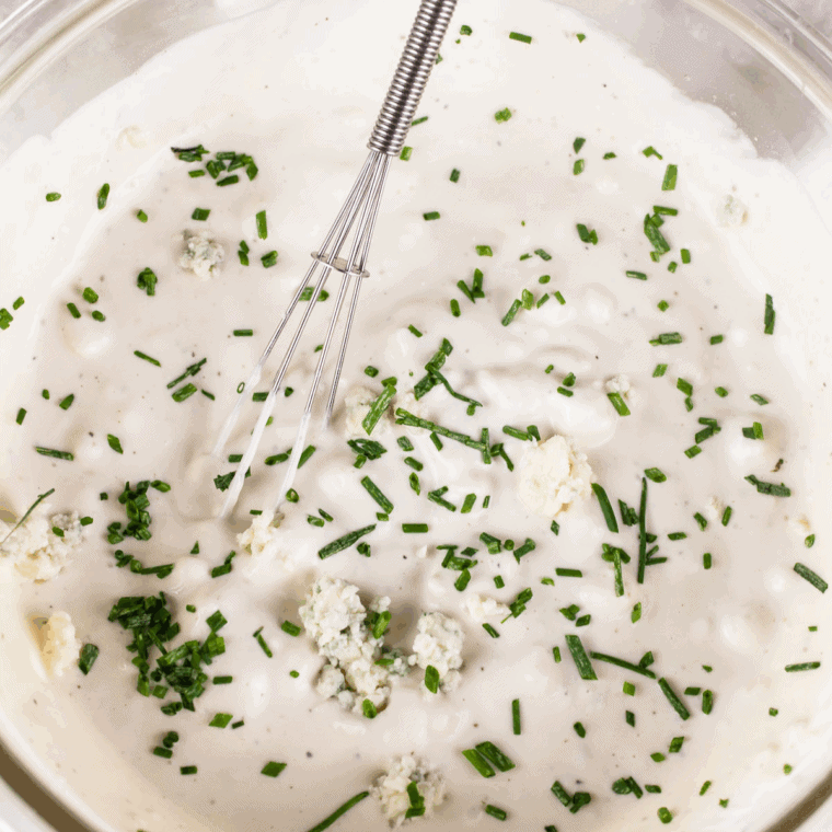 A bowl of Easy Copycat Jason's Deli Ranch Dressing Recipe with a mixer sitting on the kitchen table.