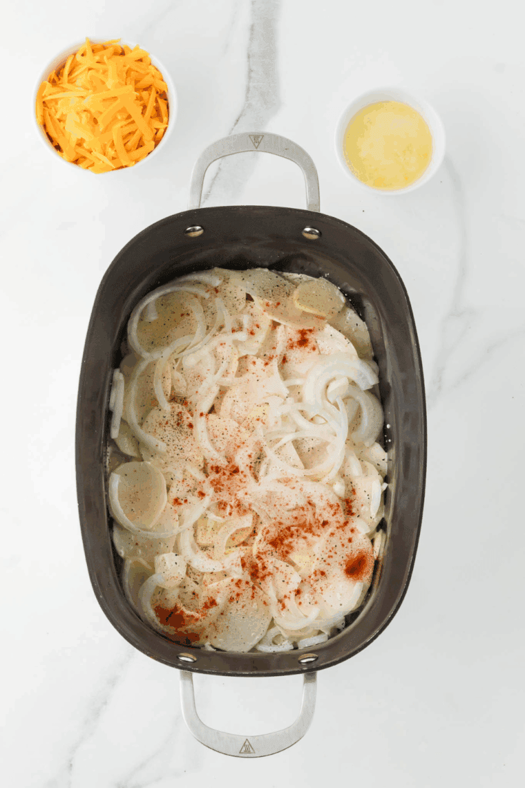Thinly sliced potatoes and onions layered in crockpot