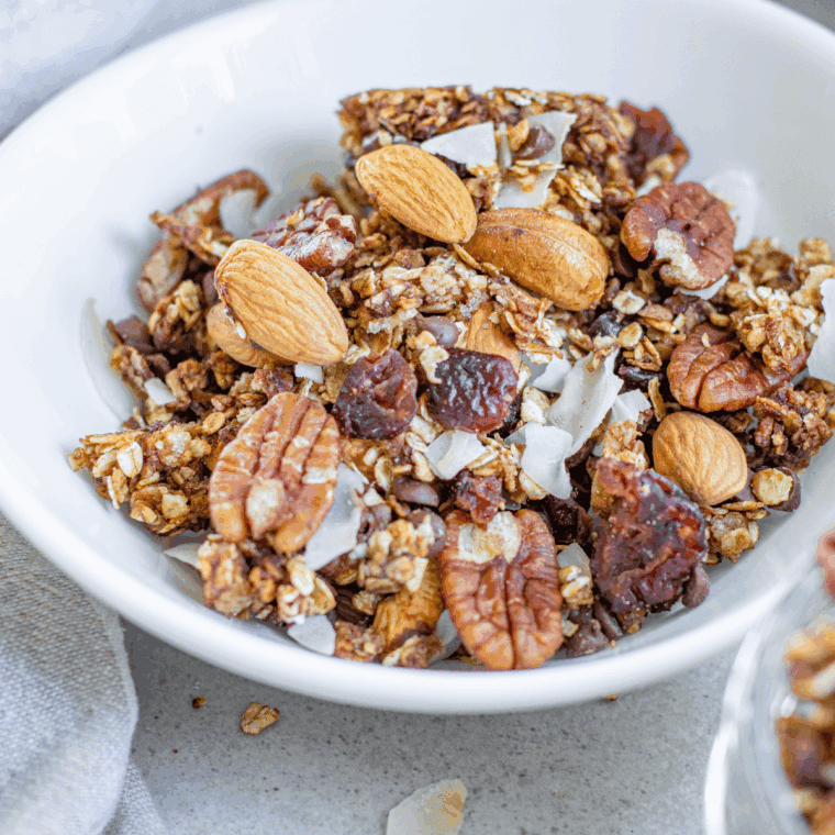 Bowl of crunchy homemade First Watch copycat granola with oats and nuts.