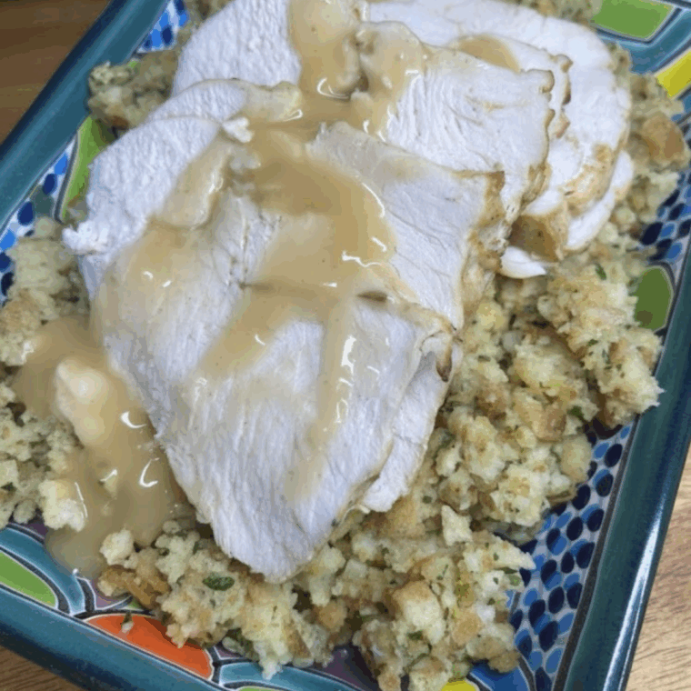 Golden, crispy frozen boneless turkey breast cooking in an air fryer basket.