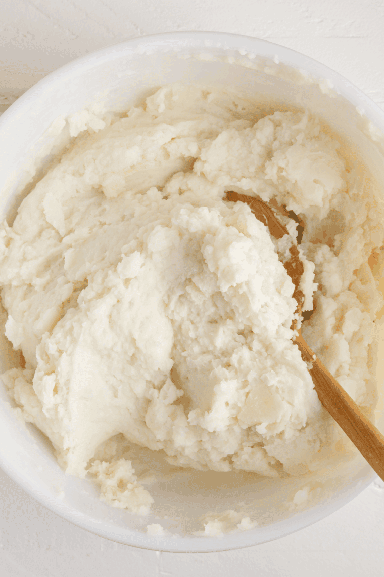 Large bowl of fluffy, rich, and creamy Golden Corral Mashed Potatoes topped with a pat of melting butter.