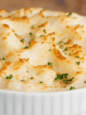 Large bowl of fluffy, rich, and creamy Golden Corral Mashed Potatoes topped with a pat of melting butter.