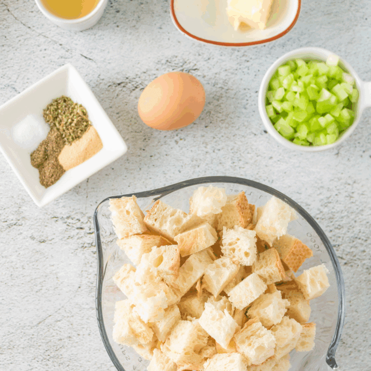 The ingredients needed for this easy Ina Garten Sausage and Herb Stuffing are. On the kitchen table.