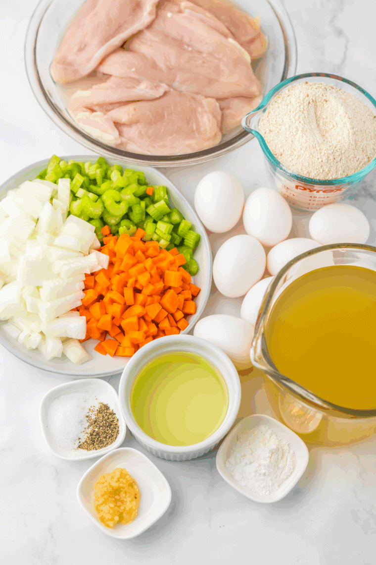 Ingredients needed for Easy Slow Cooker Matzo Ball Soup Recipe on kitchen table.
