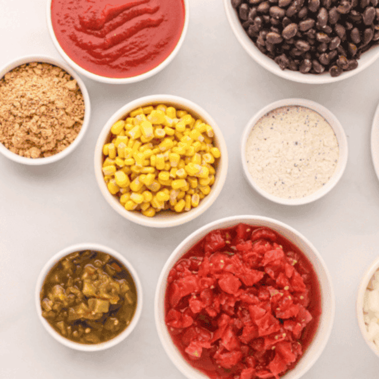 Ingredients needed for Easy Slow Cooker Pulled Pork Chili on kitchen table.