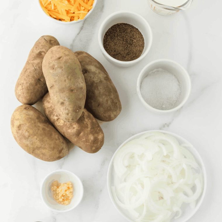 Ingredients needed for Easy Slow Cooker Scalloped Potatoes Recipe on kitchen table.
