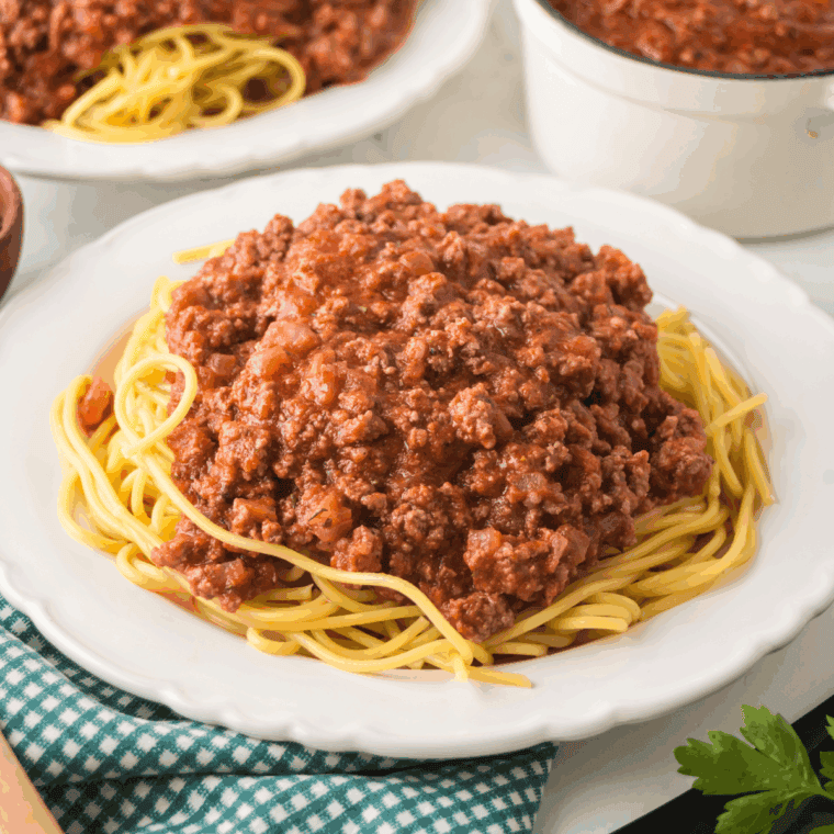 Homemade spaghetti seasoning in a small bowl with dried herbs and spices.