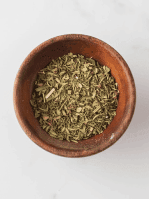 Jar of homemade spaghetti seasoning made with mixed dried herbs and spices.