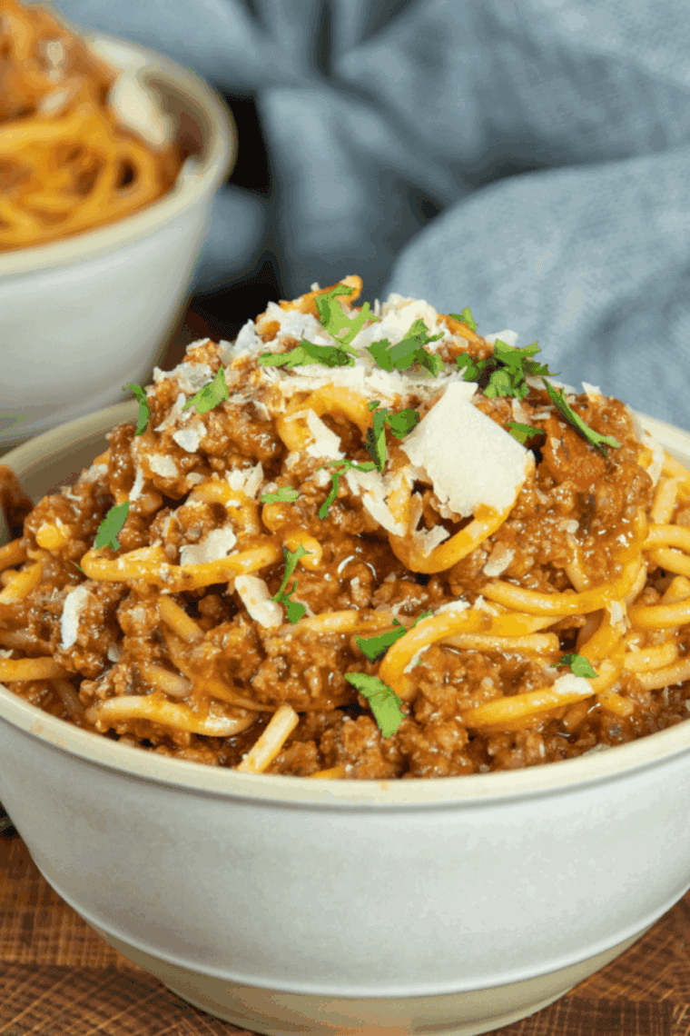 Homemade spaghetti seasoning in a small bowl with mixed dried herbs and spices.
