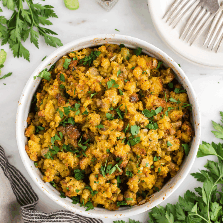 Baked Ina Garten's Cornbread Stuffing in a casserole dish, showing the mixture of cornbread, herbs, and savory vegetables.