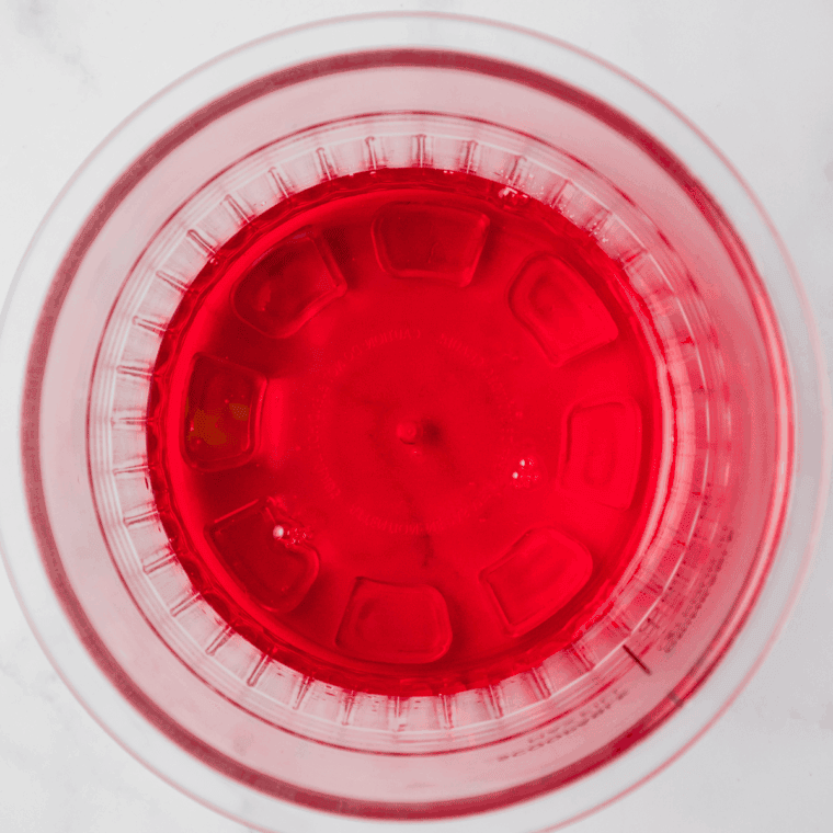 Mixing cotton candy syrup and water in a bowl until fully combined.