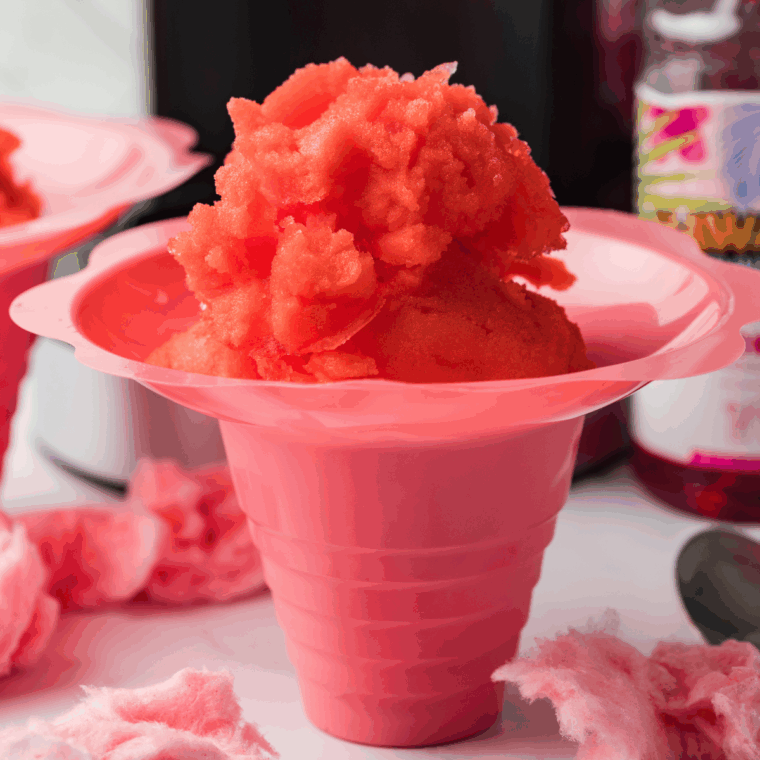 Bowl of pink and blue cotton candy Italian ice made in a Ninja Creami.