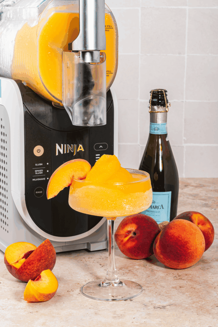 Pouring frozen Peach Bellini into glasses, garnished and ready to serve.