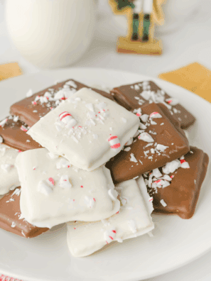 Stacked Easy Peppermint Crunch Graham Crackers dipped in white chocolate and generously covered with crushed red and white candy canes.