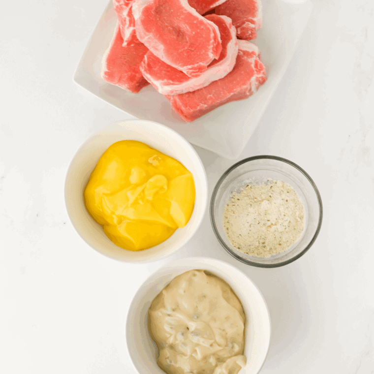 Ingredients needed for Easy Slow Cooker Creamy Ranch Pork Chops on kitchen table.