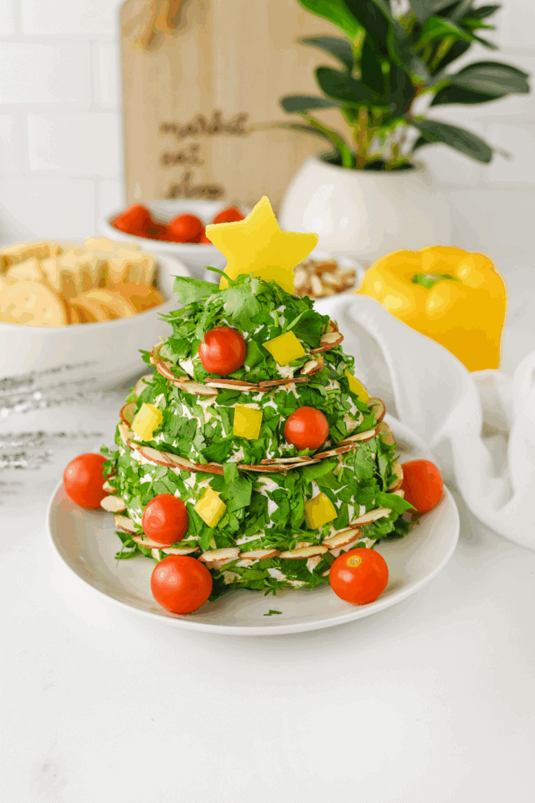 Christmas Tree Cheese Ball wrapped in plastic wrap and stored in the refrigerator