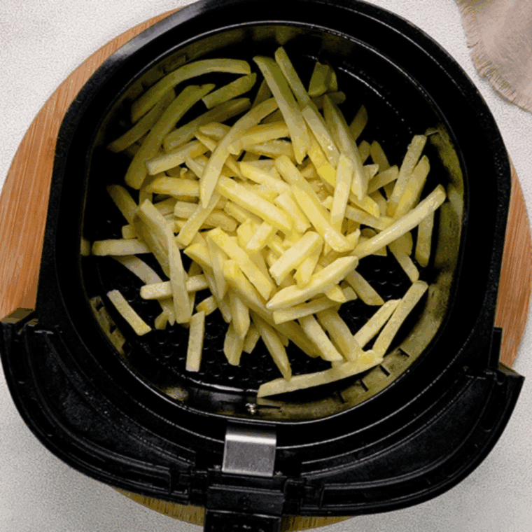 Place French fries into the air fryer basket.