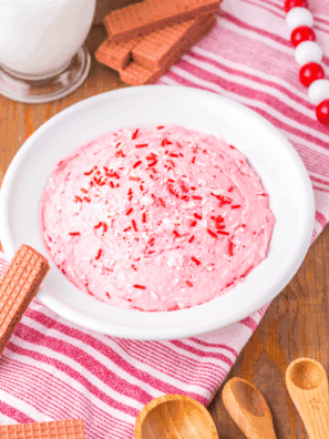 Bowl of creamy Easy 2-Minute Peppermint Fluff topped with crushed candy canes.