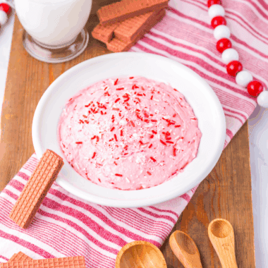 Bowl of creamy Easy 2-Minute Peppermint Fluff topped with crushed candy canes.