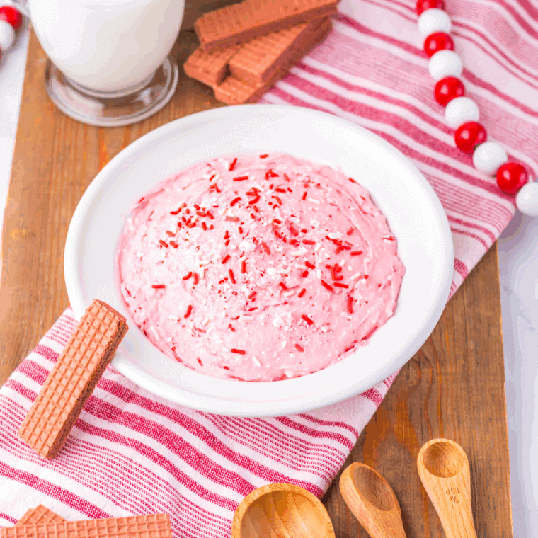Bowl of creamy Easy 2-Minute Peppermint Fluff topped with crushed candy canes.