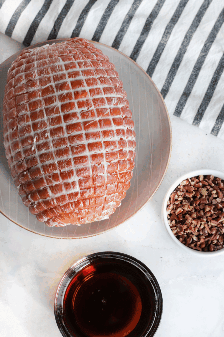 Preheating the air fryer and removing the ham from packaging.