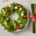 Bring the holiday spirit to your table! This Easy Christmas Wreath Salad is a beautiful, festive appetizer made with fresh greens, colorful veggies, and a tangy dressing, shaped to look just like a decorative wreath. Perfect for holiday entertaining!