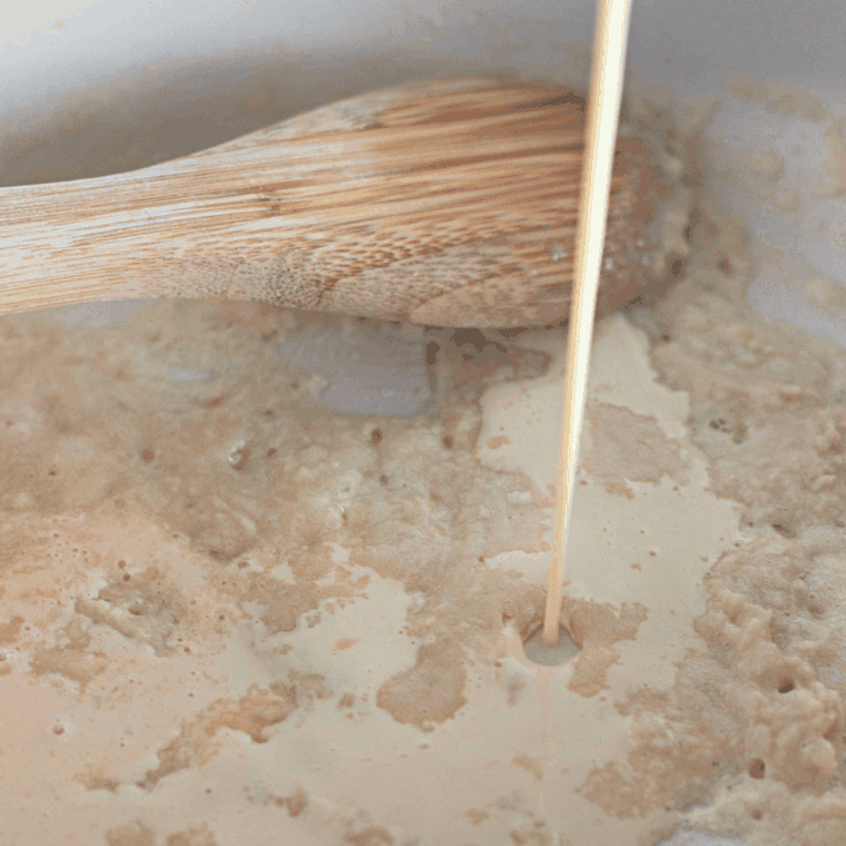 Melting butter and whisking in flour to create a smooth roux.