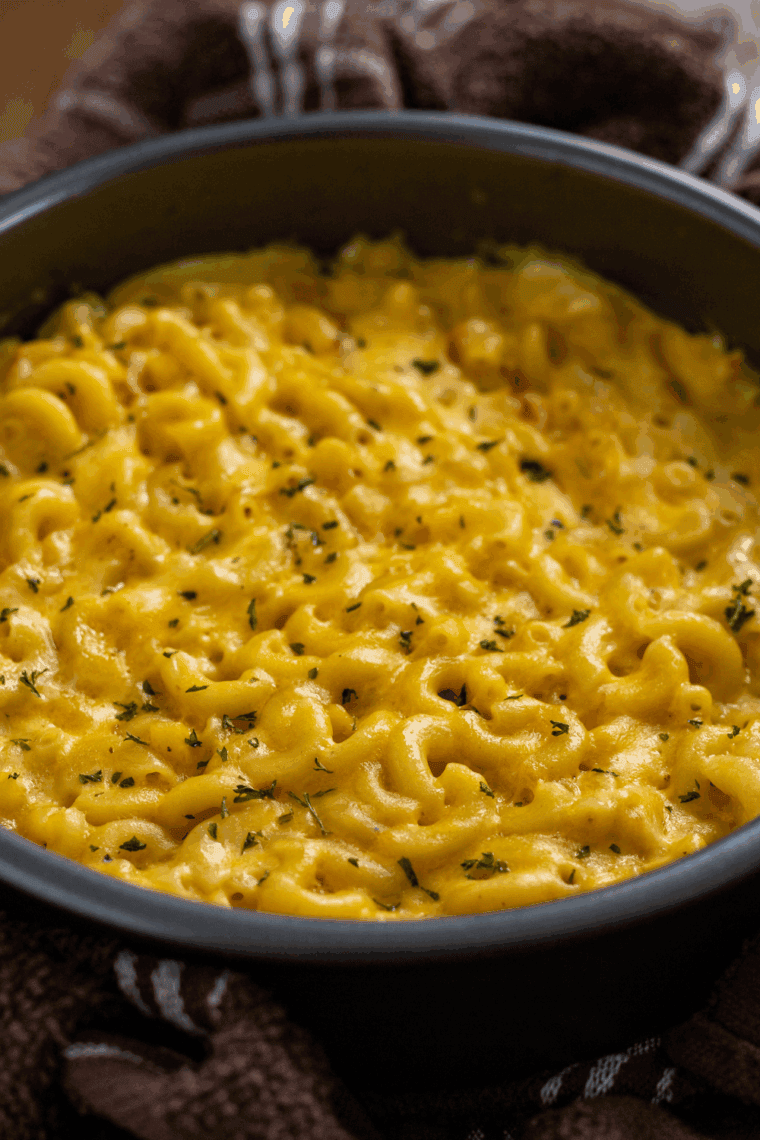 Homemade copycat Olive Garden mac and cheese in a bowl, creamy and cheesy, garnished with parsley.