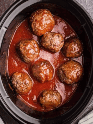 Crock pot filled with tender, cooked frozen meatballs in savory sauce