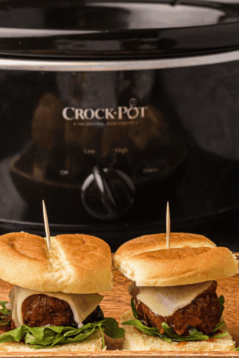 Crock pot filled with cooked frozen meatballs in savory marinara sauce