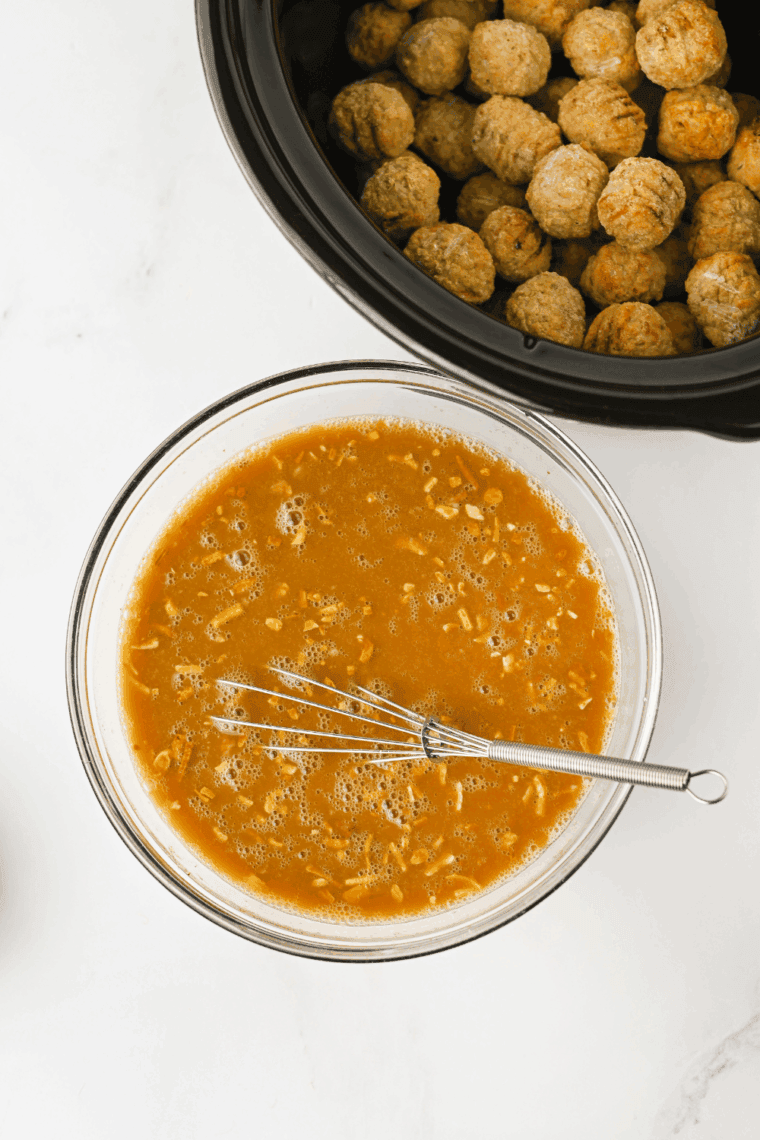 Whisking cream of mushroom soup, onion soup mix, Worcestershire sauce, and beef broth in a bowl.