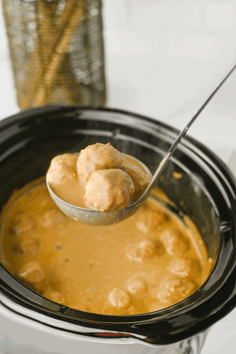 Stirring sour cream into crockpot for rich, creamy sauce.
