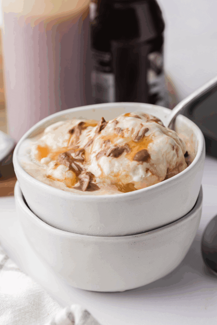 Bowl of homemade Ninja Creami Ben and Jerry’s Vanilla Caramel Fudge with caramel swirls and chocolate chunks